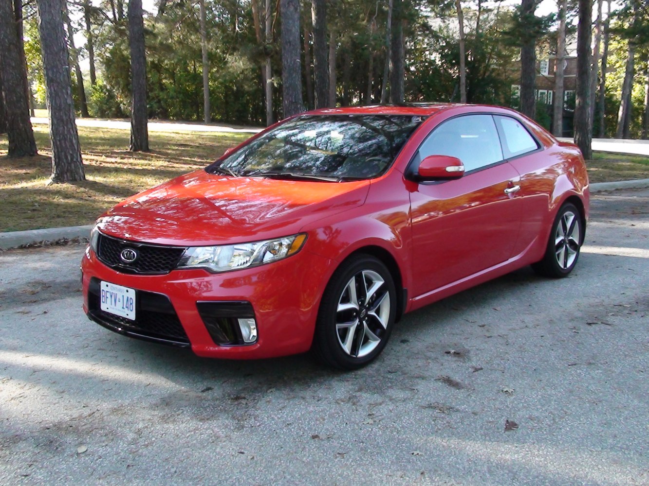 Red two-door coupe with sporty design and alloy wheels