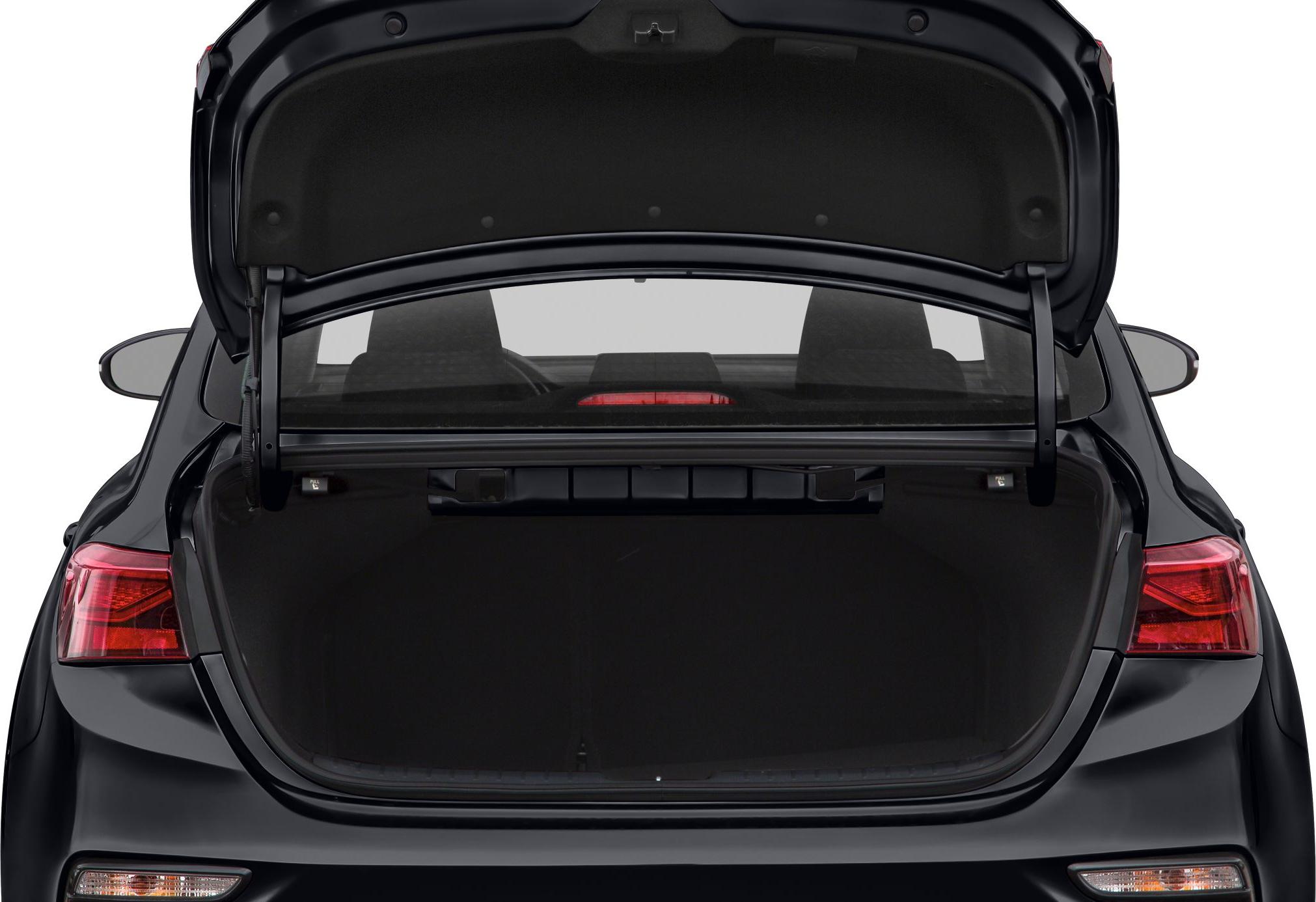 Open rear trunk storage space of a sedan with visible trunk lid