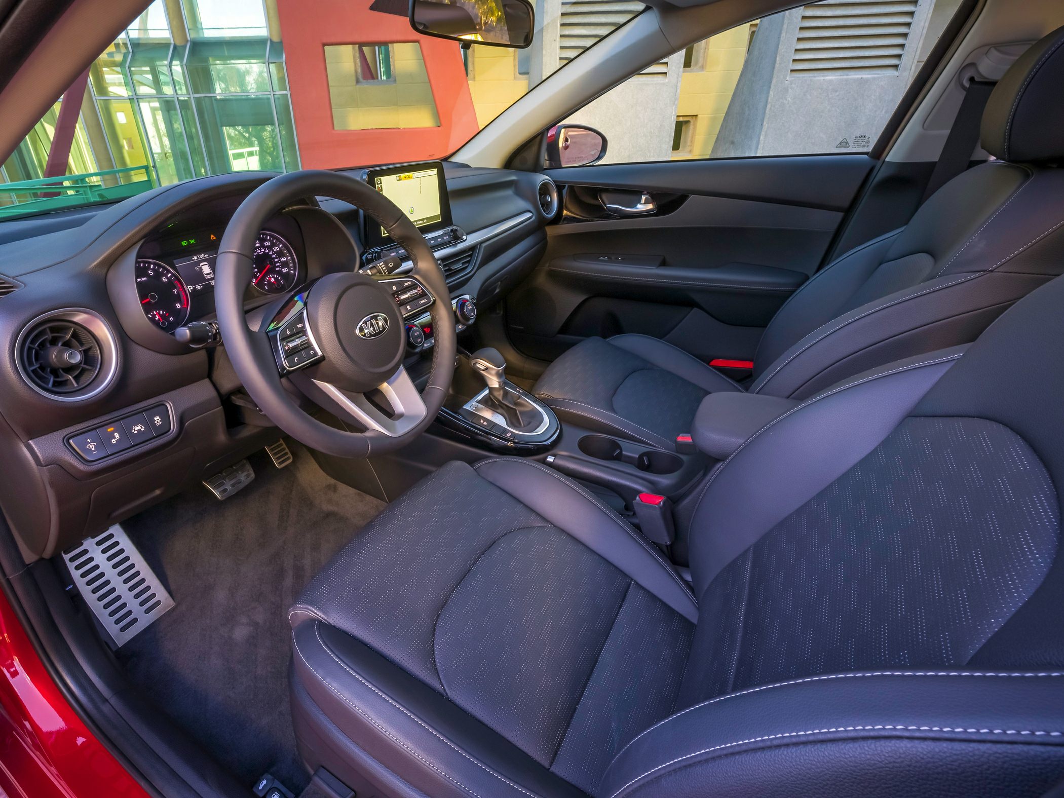 Modern car interior with touchscreen, leather seats, and advanced dashboard controls