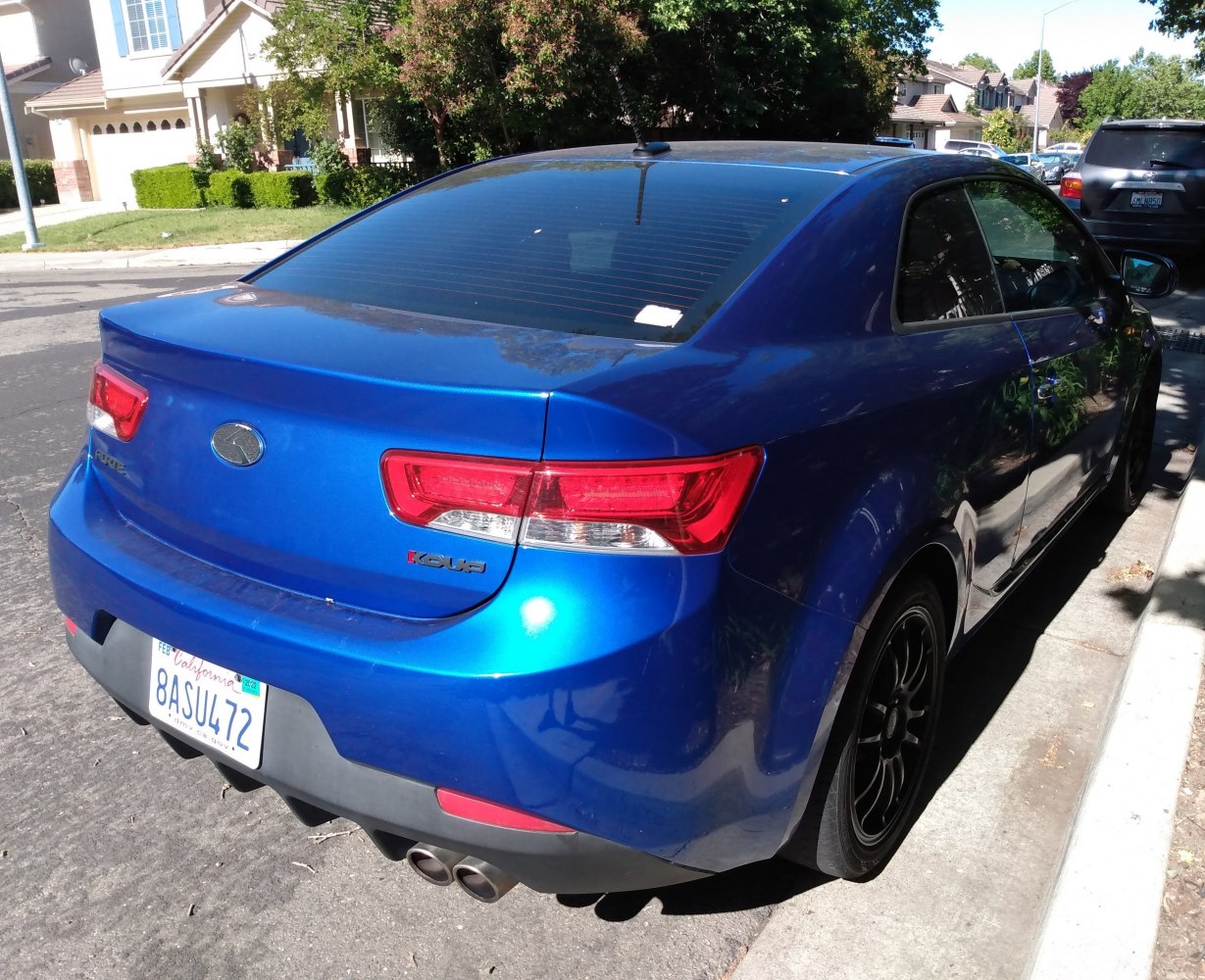 Sporty coupe rear with dual exhaust and taillights