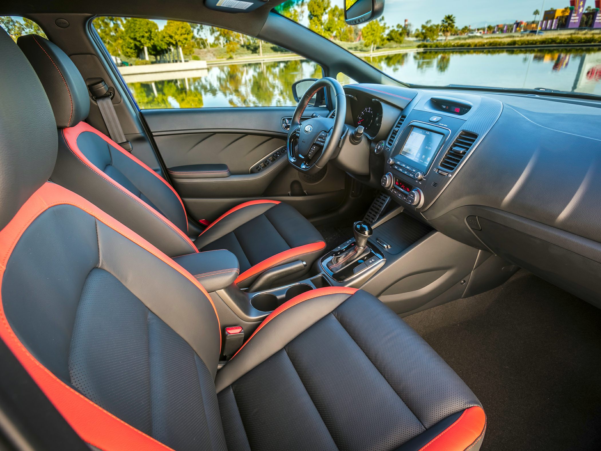 Sporty black and orange seats with modern dashboard and touchscreen center console