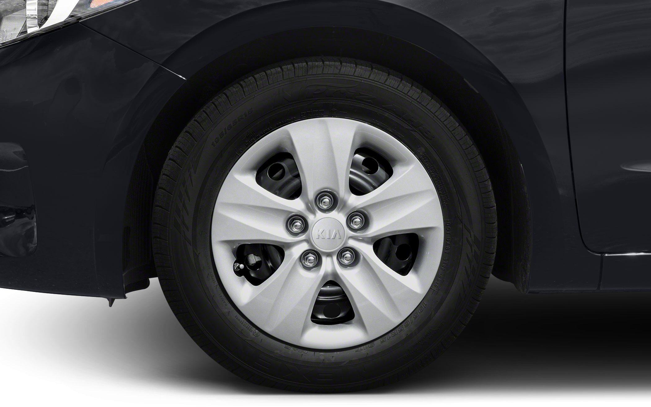 Close-up of wheel and tire with steel rim and hubcap.