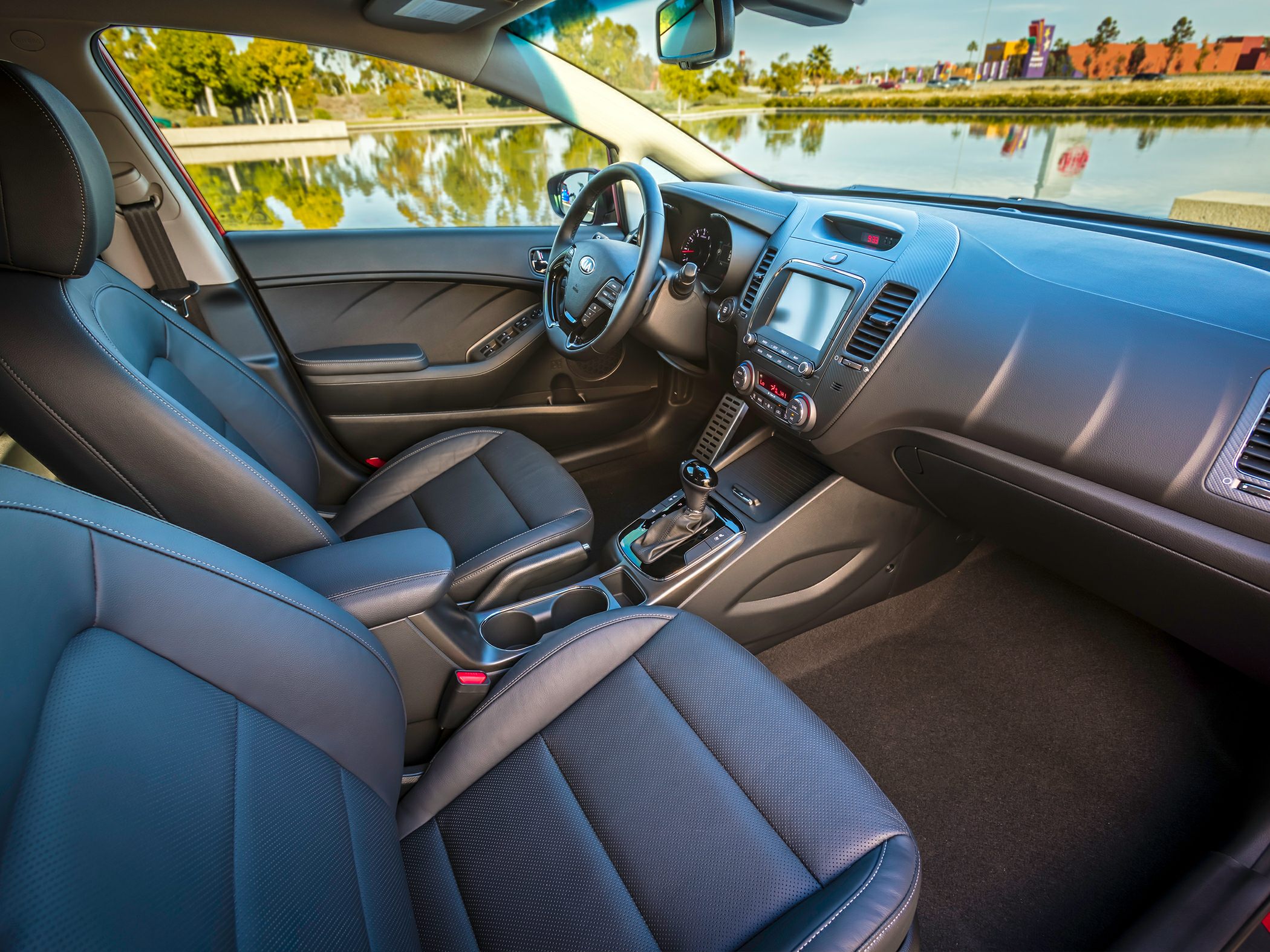 Leather seats and touchscreen infotainment in modern car interior