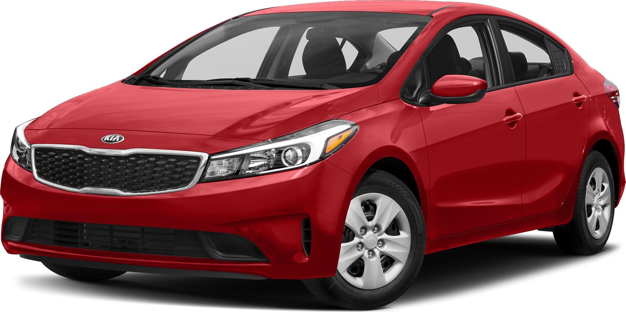 Red sedan front side view with headlight and grille