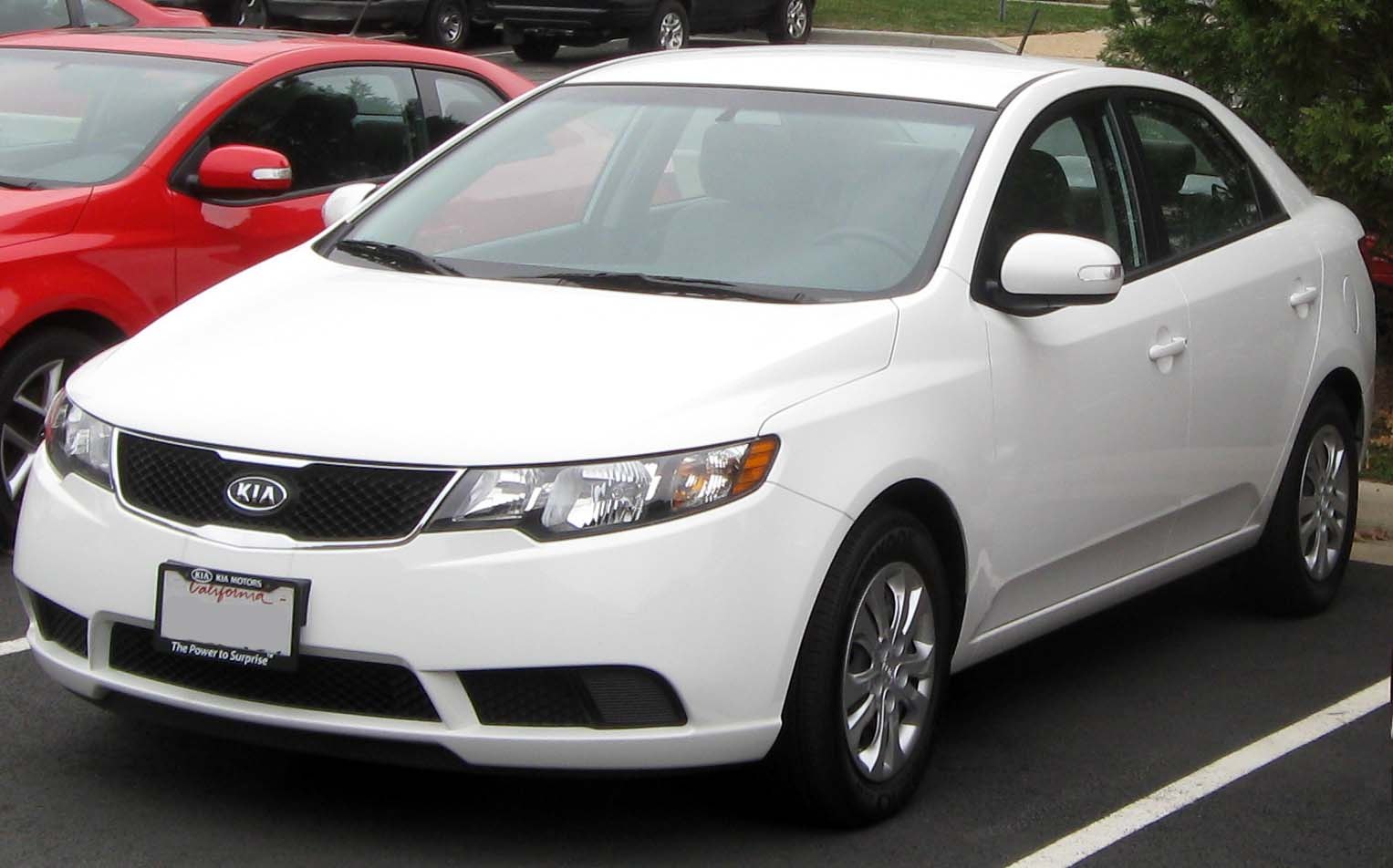 White compact sedan with distinctive front grille and headlights