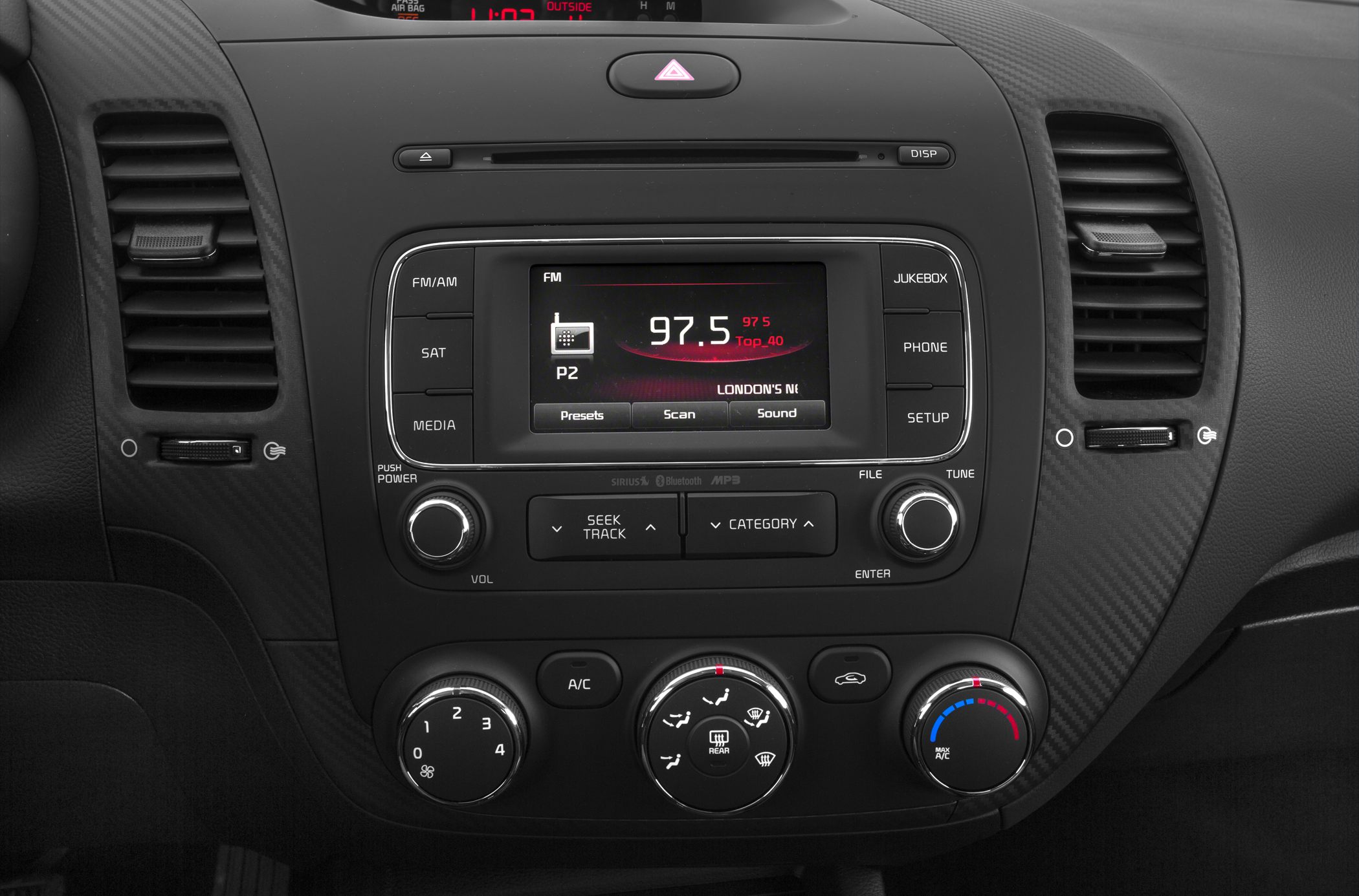 Car radio and manual climate control panel in vehicle dashboard