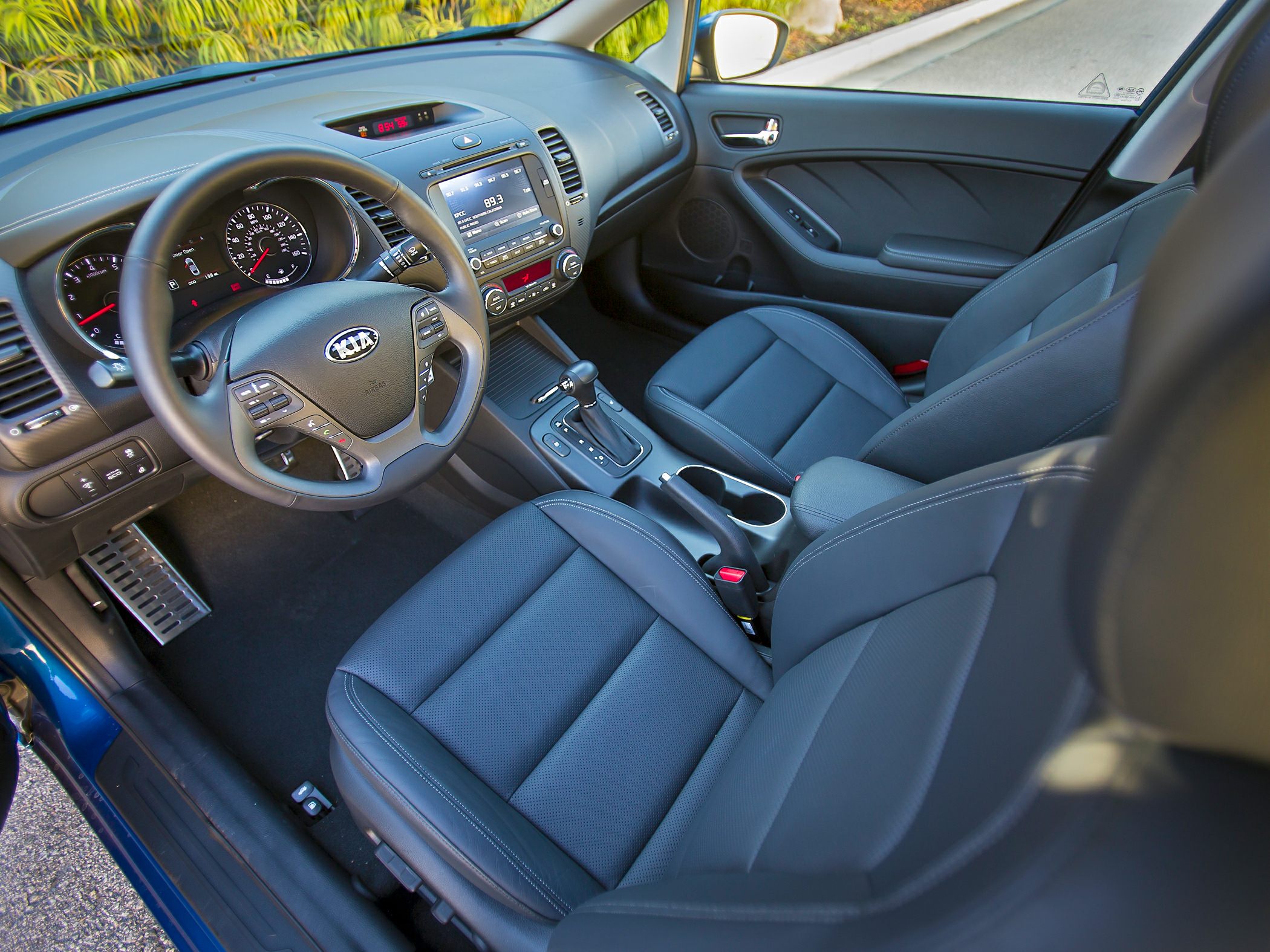 Dashboard, steering wheel, and front seats in car interior