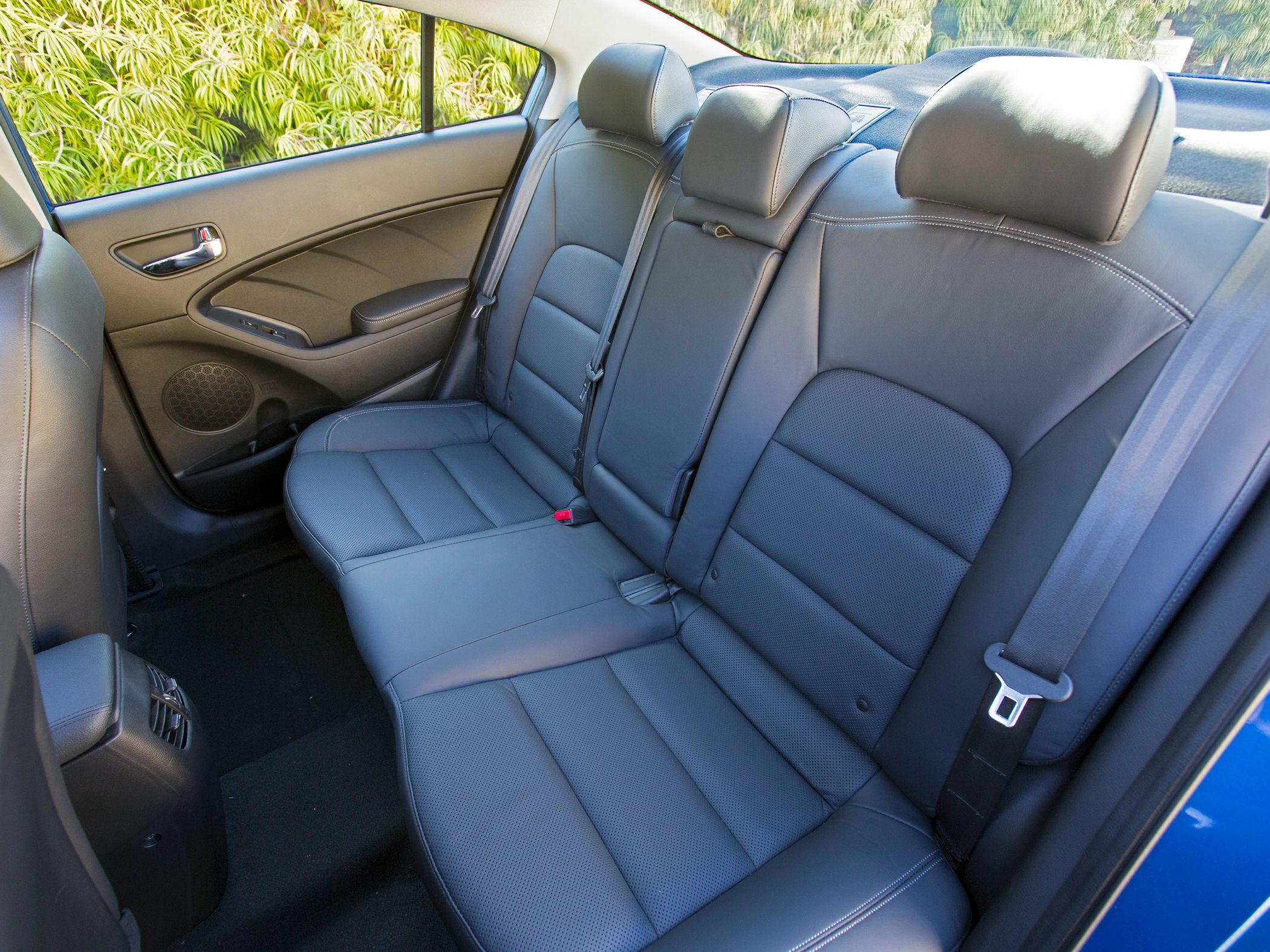 Rear leather seats with seat belts and headrests in a sedan interior