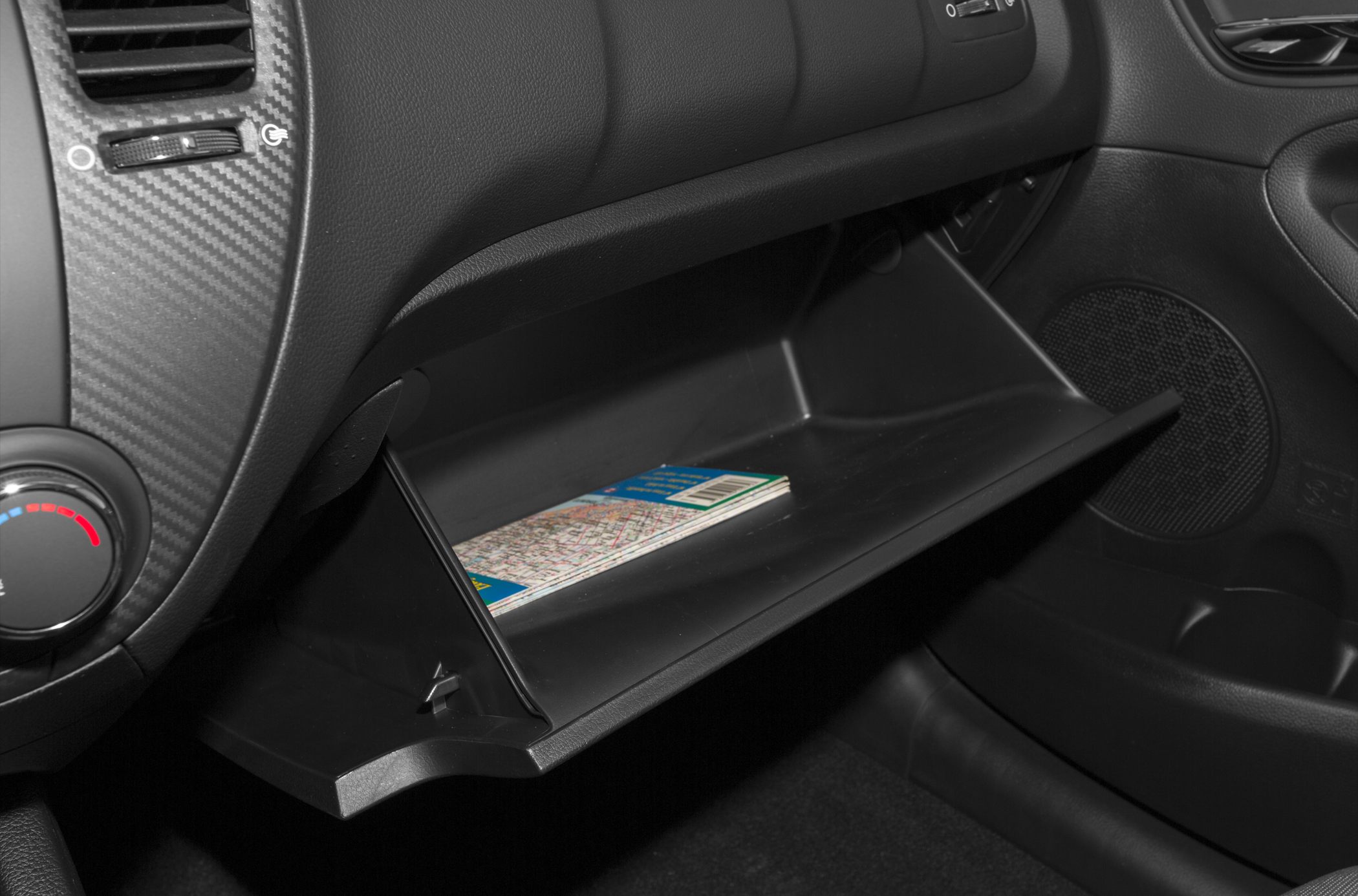 Glove compartment and dashboard with carbon-fiber trim and climate control dial