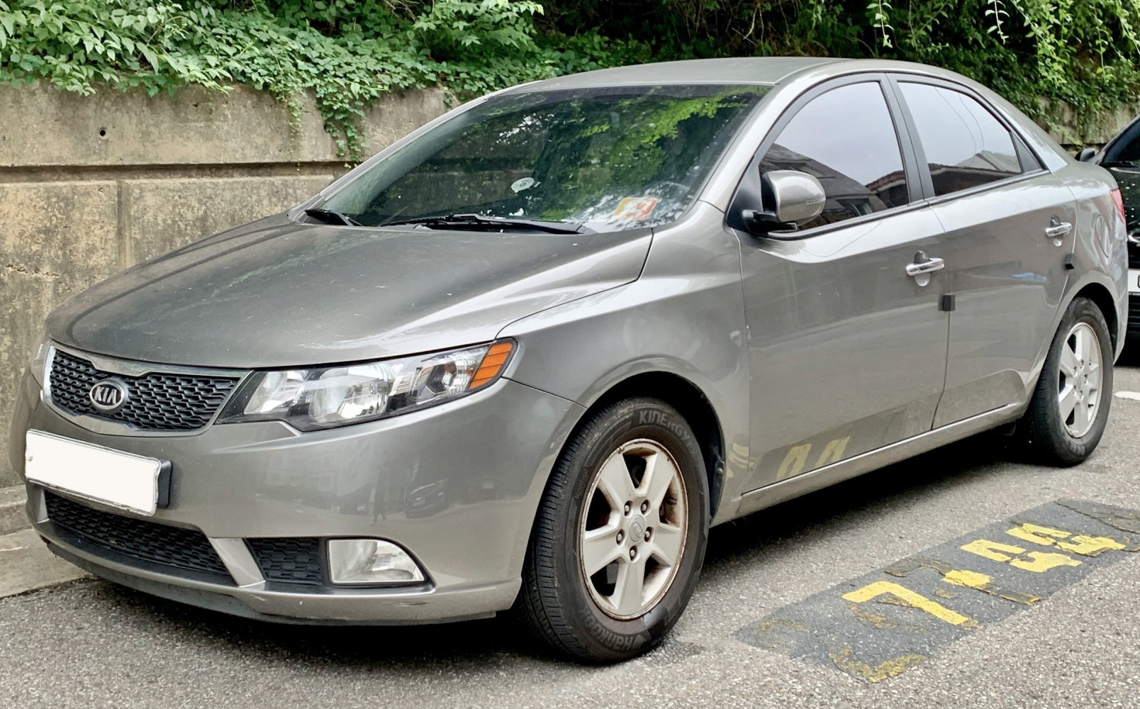 Front and side exterior view with headlights, grille, and alloy wheels