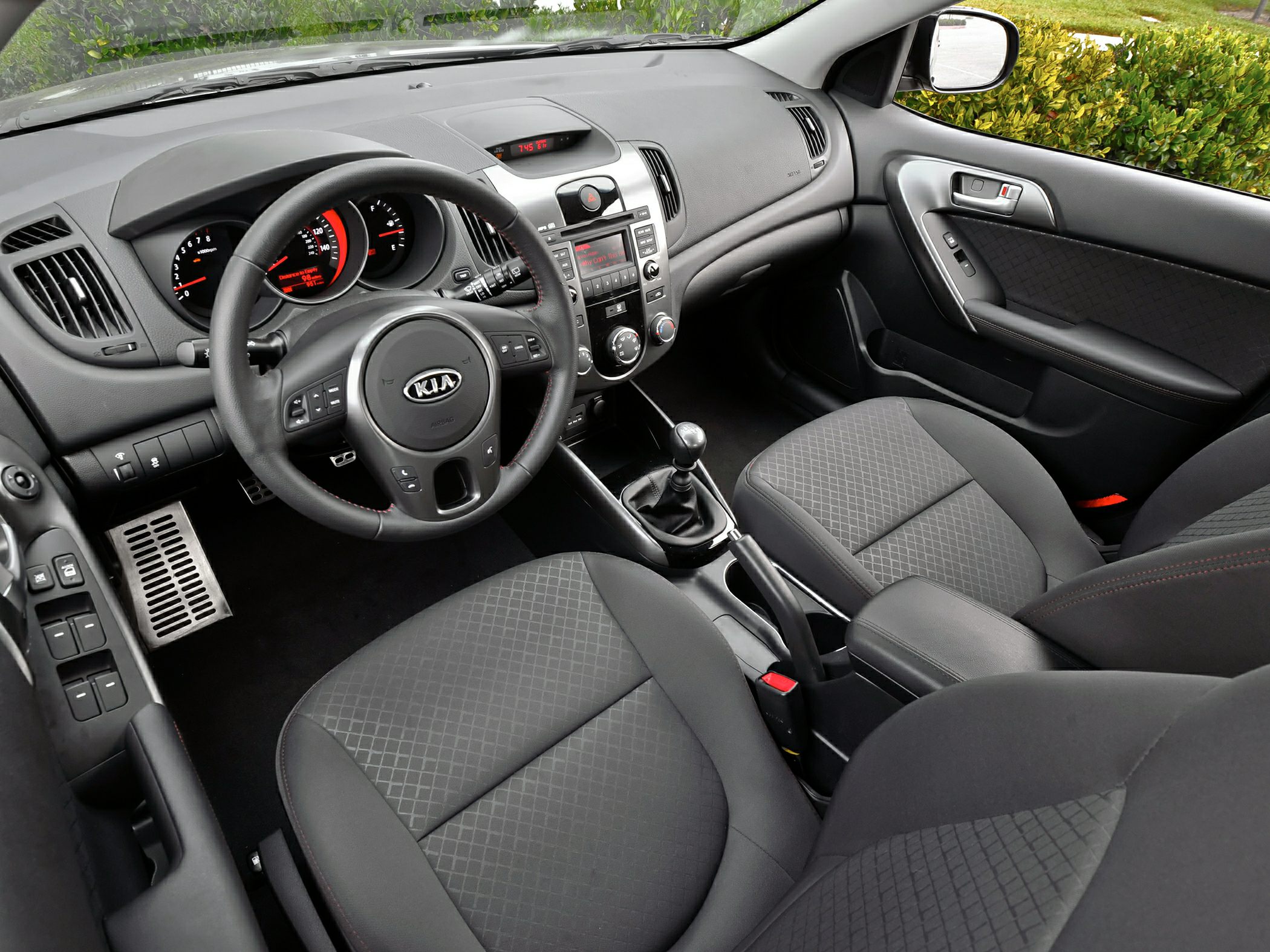 Manual transmission interior with steering wheel and dashboard