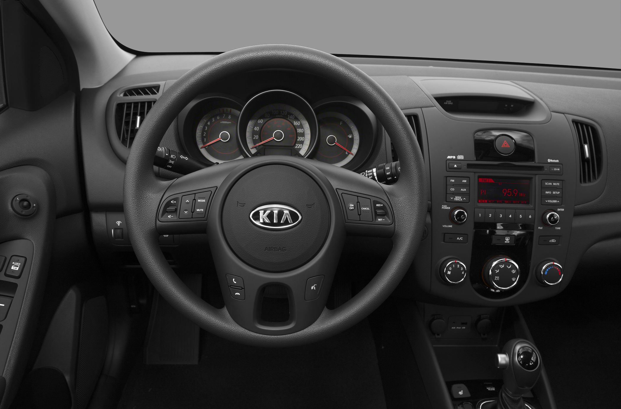 Dashboard and steering wheel with control buttons and center console layout