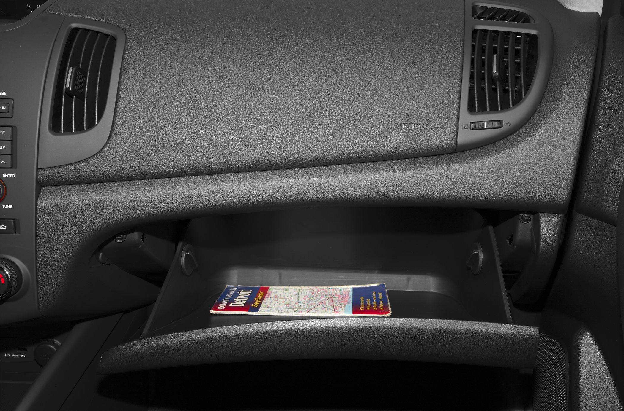 Open glove compartment with dashboard air vents