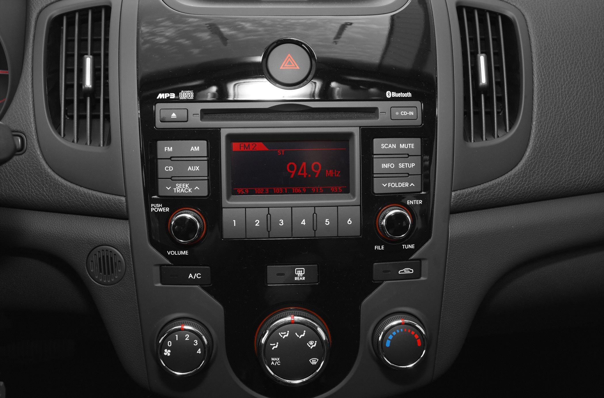 Car dashboard with audio system and climate control knobs