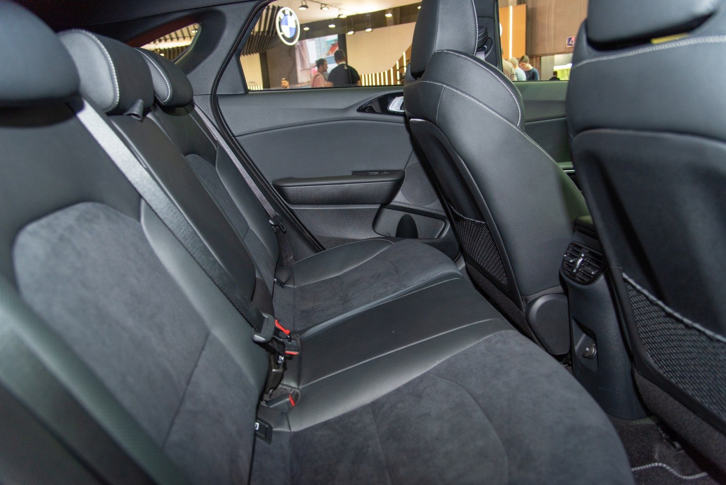 Rear seat interior with leather and Alcantara upholstery, seat belts, and rear air vents.
