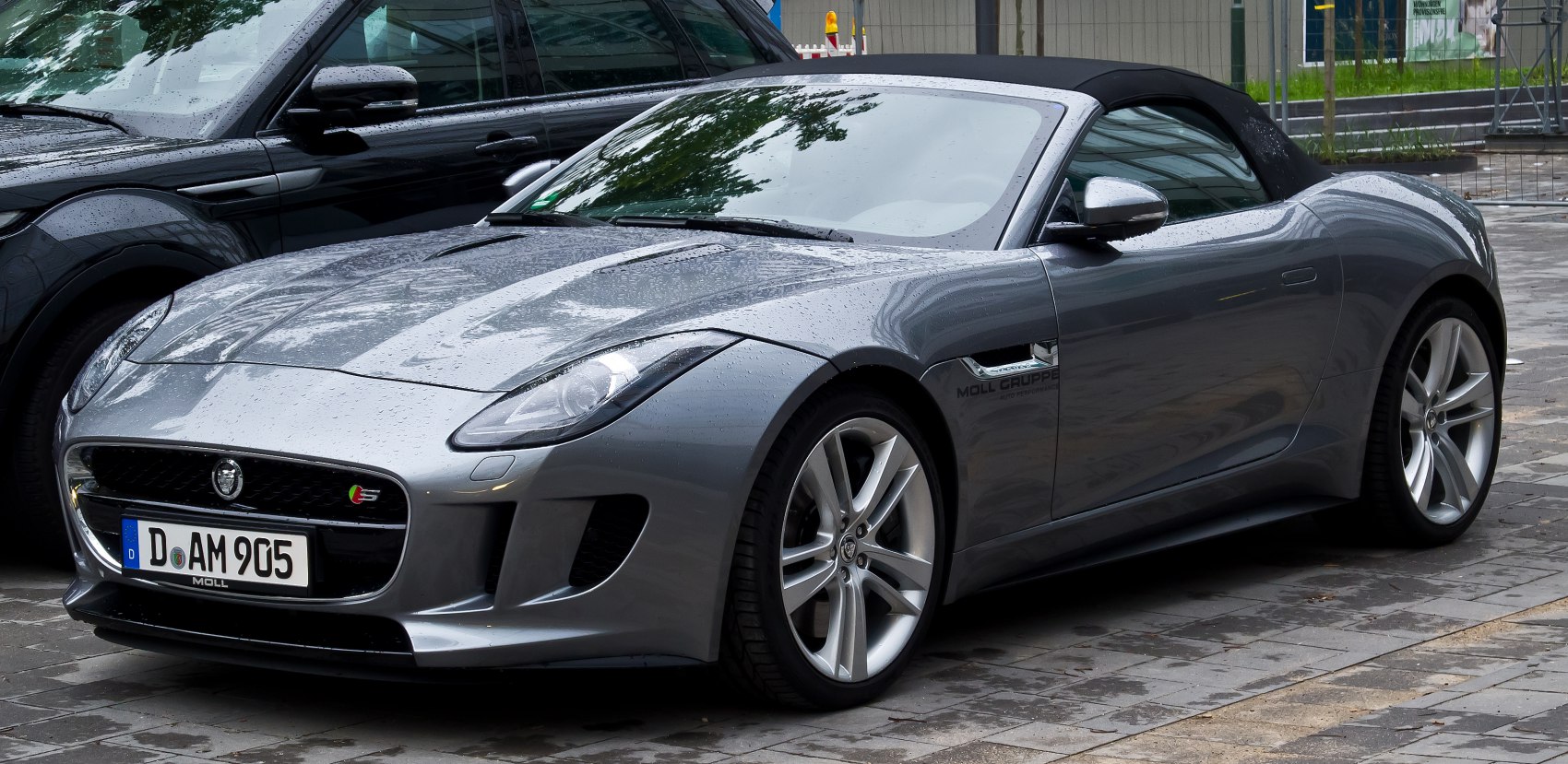 Convertible sports car frontal view with soft roof and alloy wheels