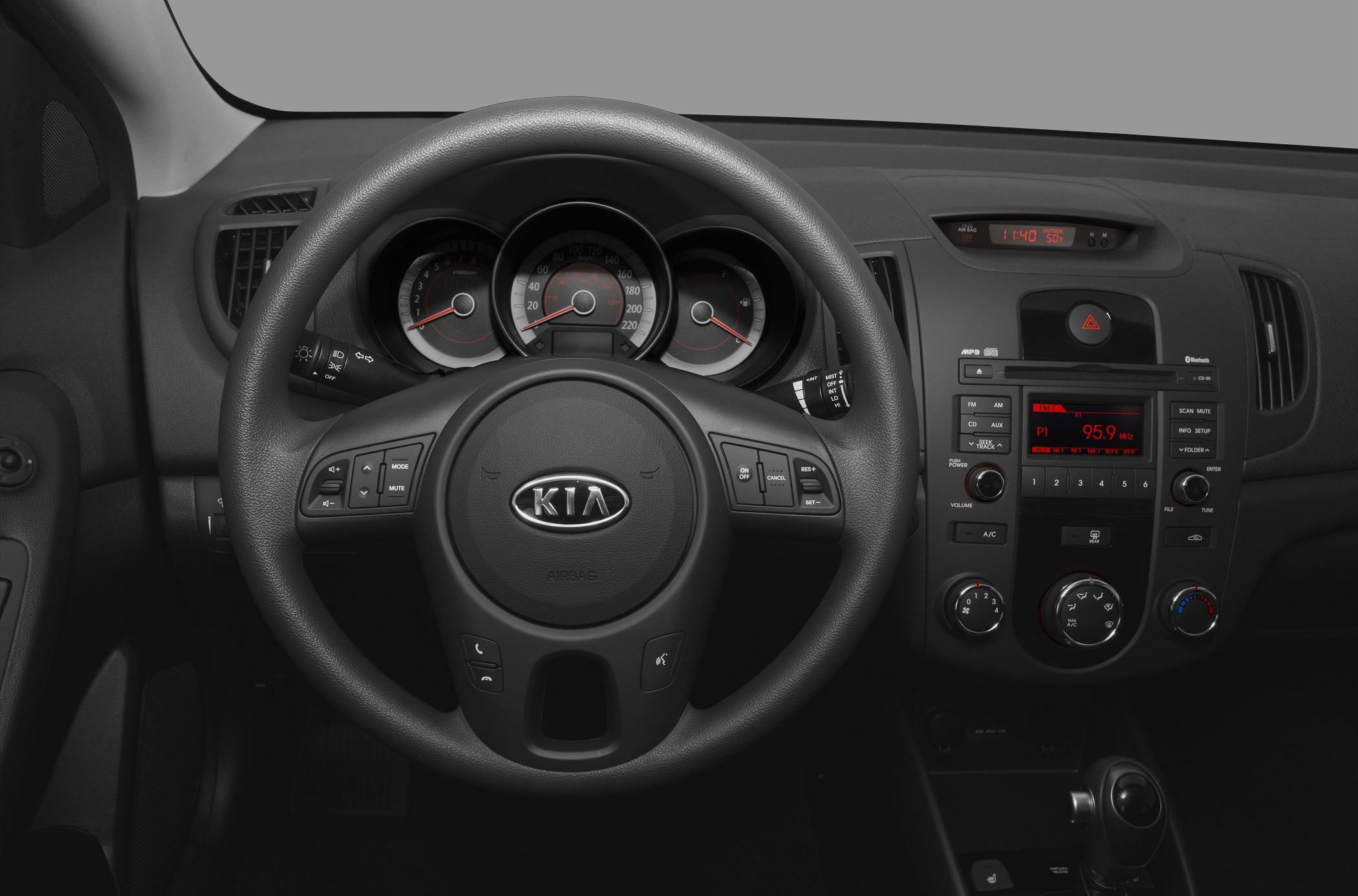 Steering wheel, instrument cluster, and center console with audio and climate controls