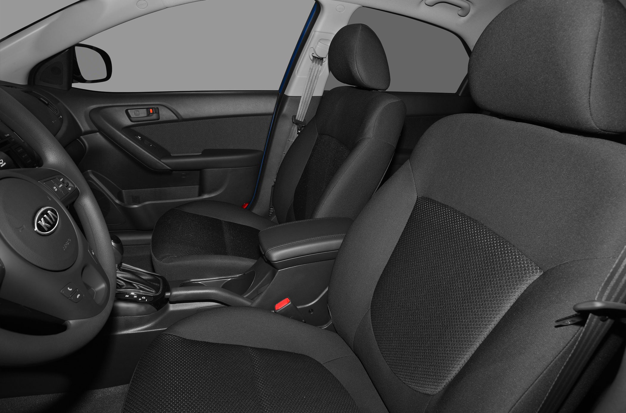 Front fabric seats and dashboard interior with steering wheel and gear shifter