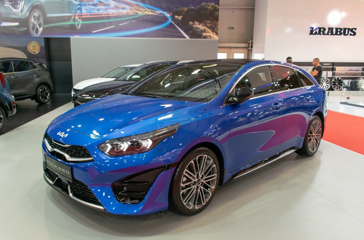 Sleek blue hatchback with athletic front and alloy wheels