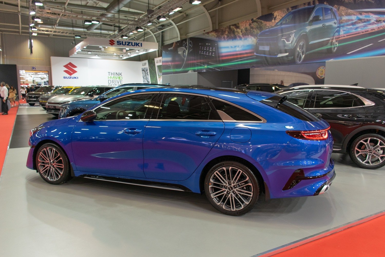 Blue fastback hatchback with alloy wheels and sleek rear styling