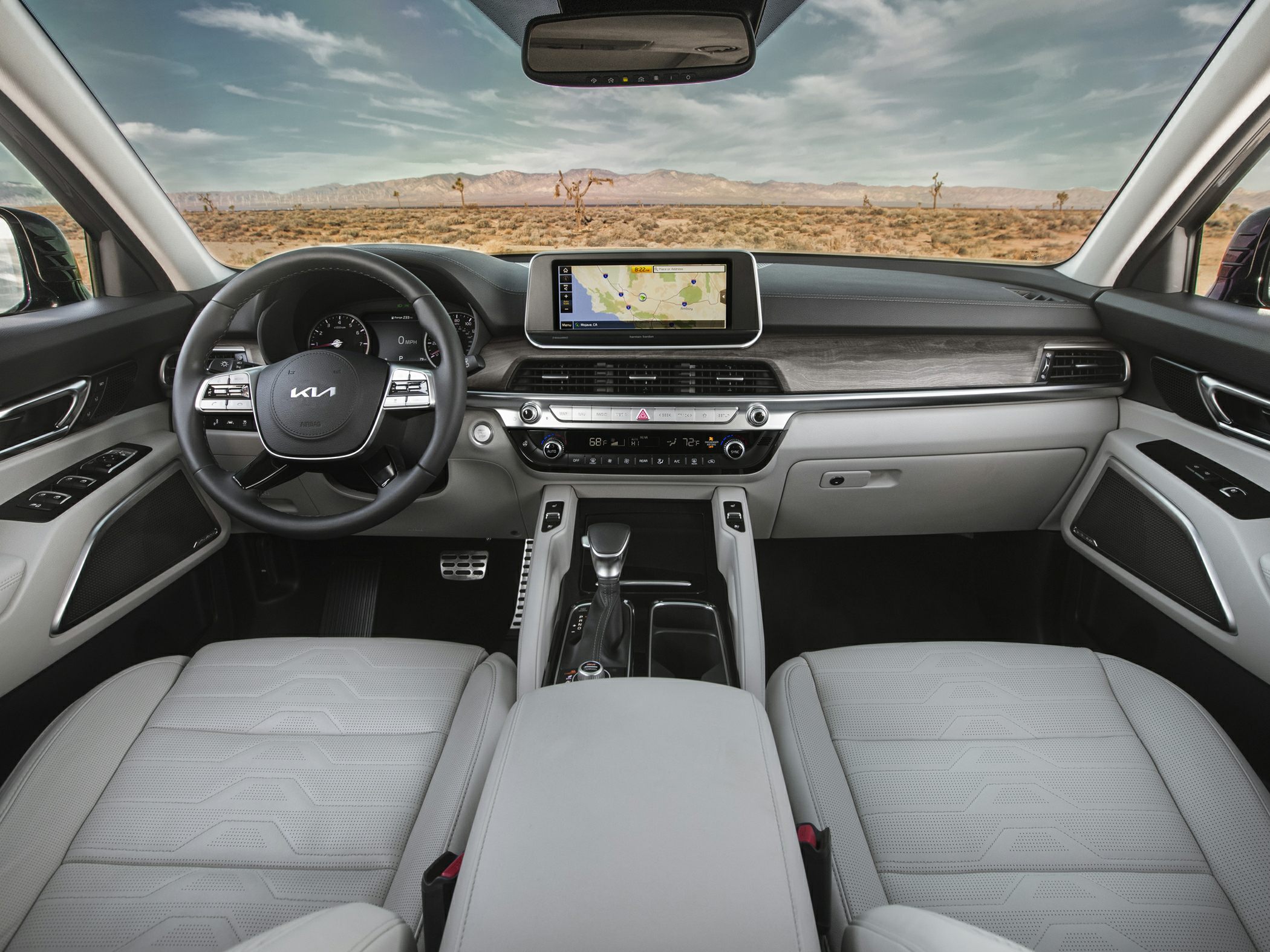 Modern vehicle interior with dashboard, navigation display, and steering wheel controls