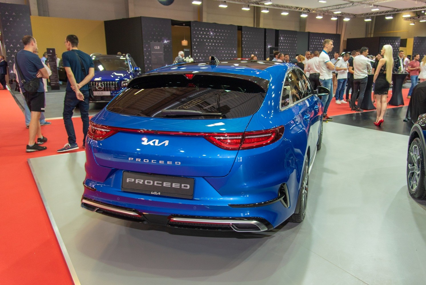 Rear view of a blue modern hatchback with sleek taillights and sporty bumper