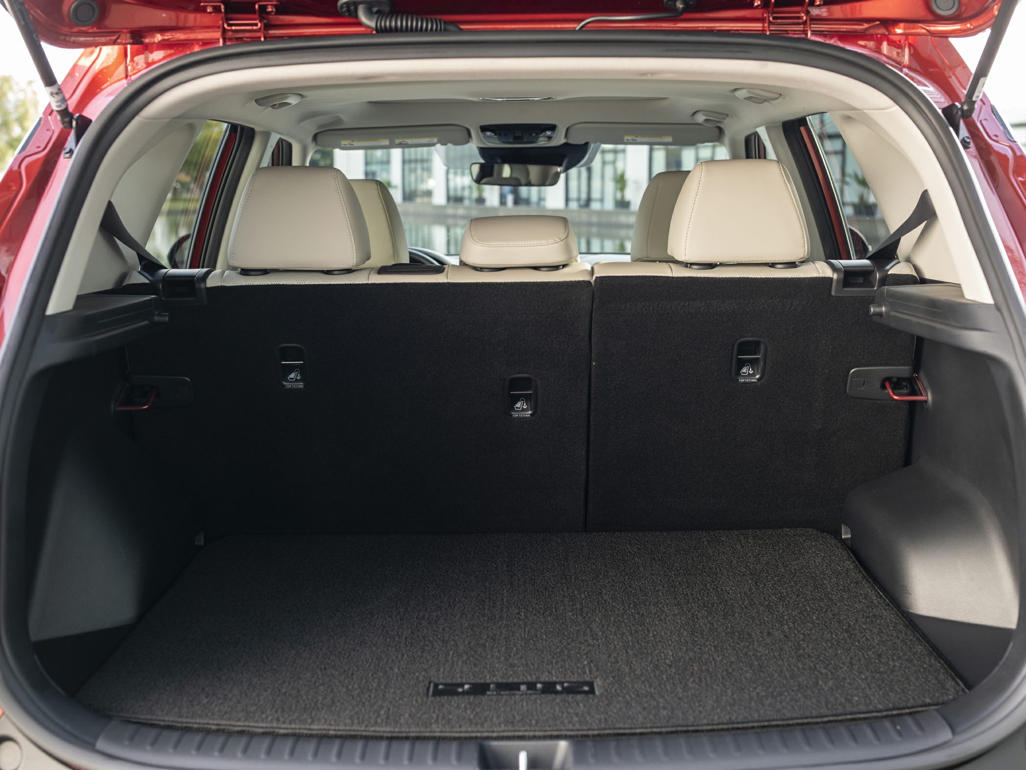 Spacious rear trunk cargo area with foldable rear seats and beige headrests