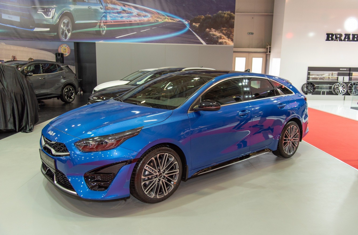 Blue sporty hatchback with sharp headlamps and alloy wheels