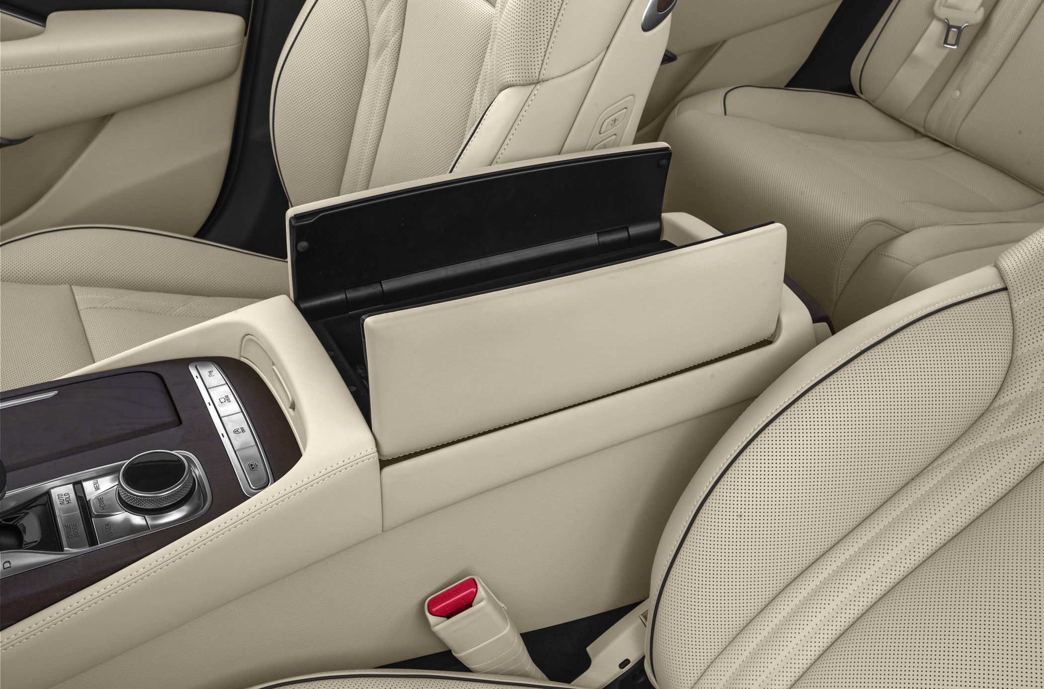 Beige perforated leather seats with center console and storage compartment