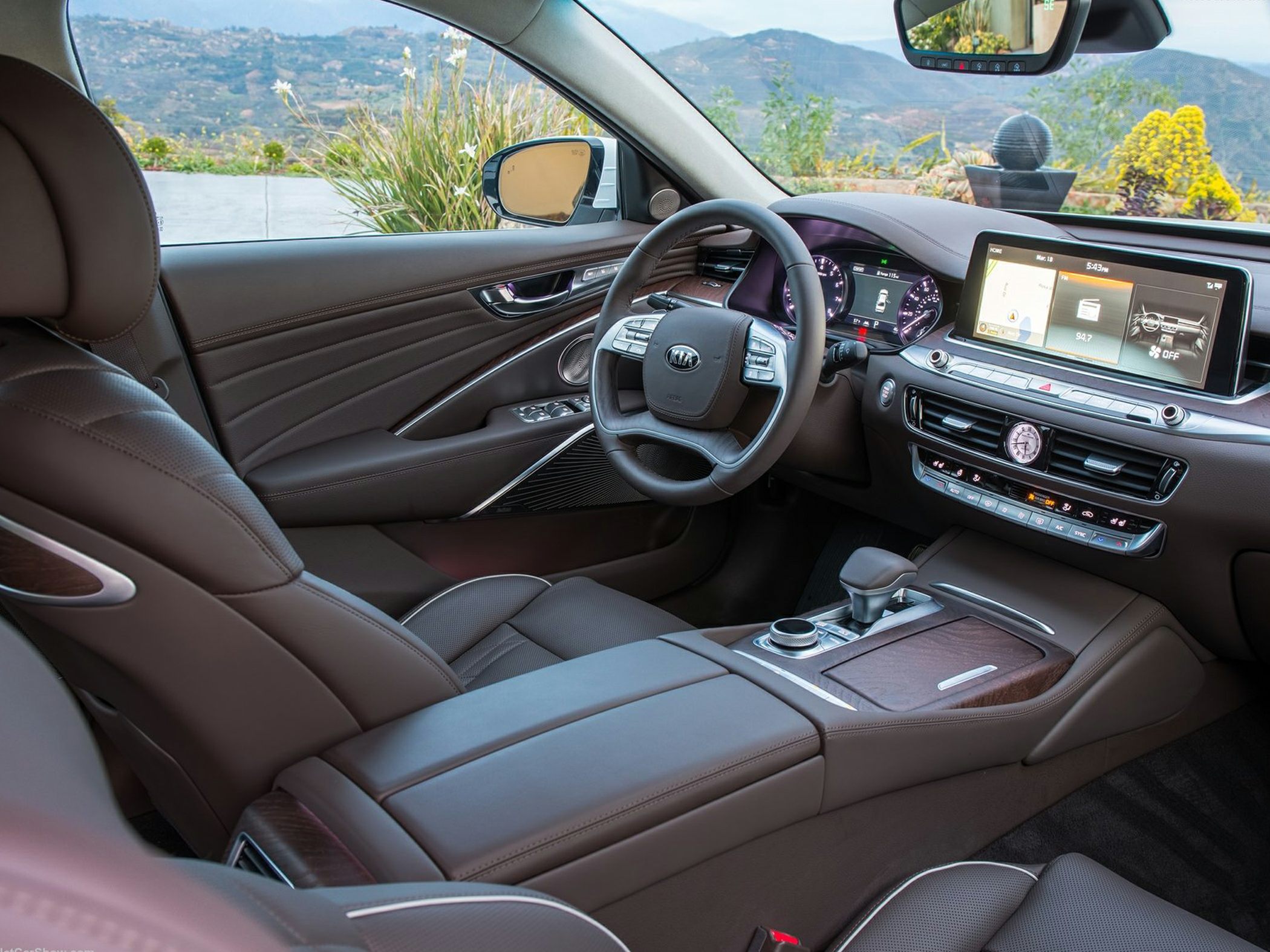 Modern car interior with digital instrument cluster and infotainment touchscreen.