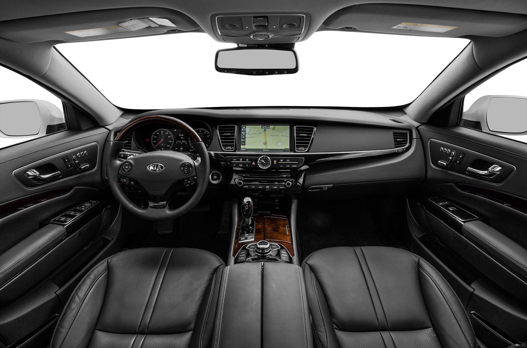 Luxury car interior with leather seats, wood trim, and digital navigation display.