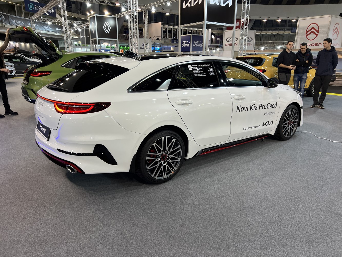 White sporty hatchback side rear view with distinctive alloy wheels