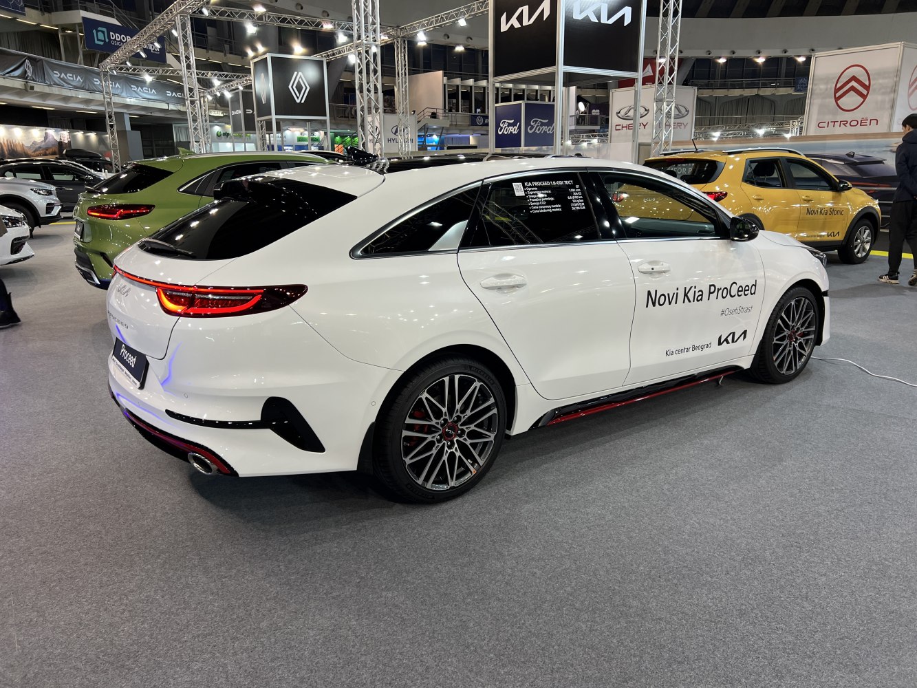 Rear and side view of white 2022 Kia ProCeed III facelift with LED lights and alloy wheels