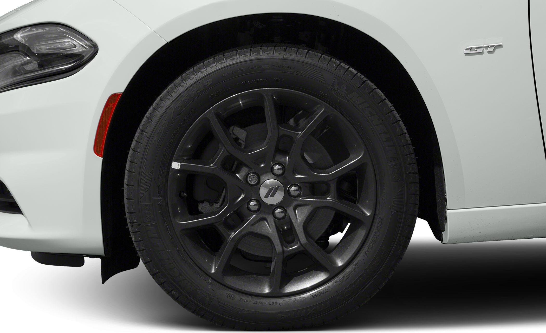 Close-up of black 19-inch alloy wheel and tire with GT badge on white car