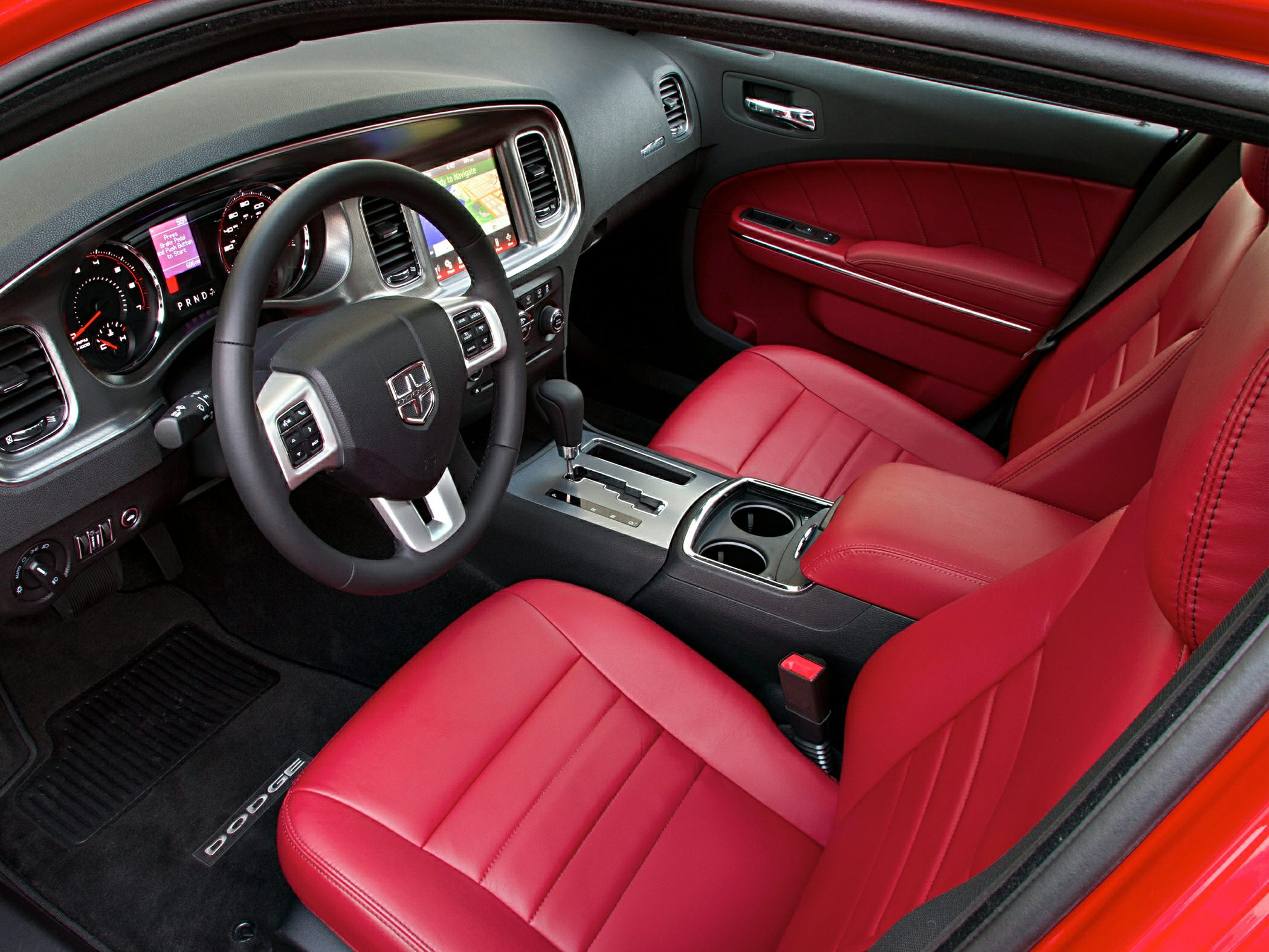 Red leather seats and modern dashboard with touchscreen infotainment