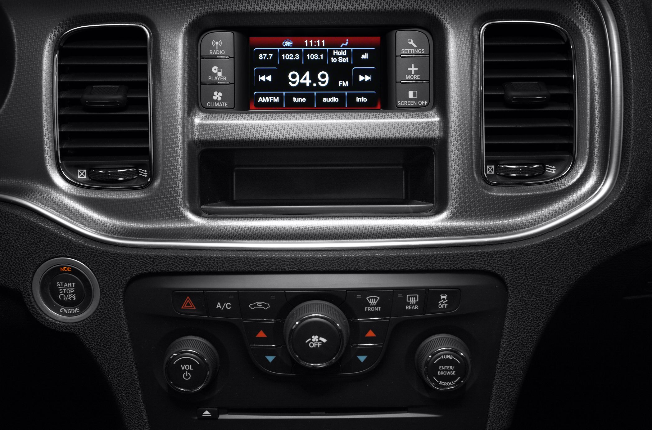 Center console with infotainment screen, climate controls, air vents, and start/stop button