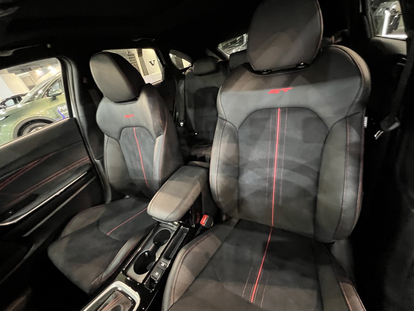 Black GT seats with red stitching and center armrest