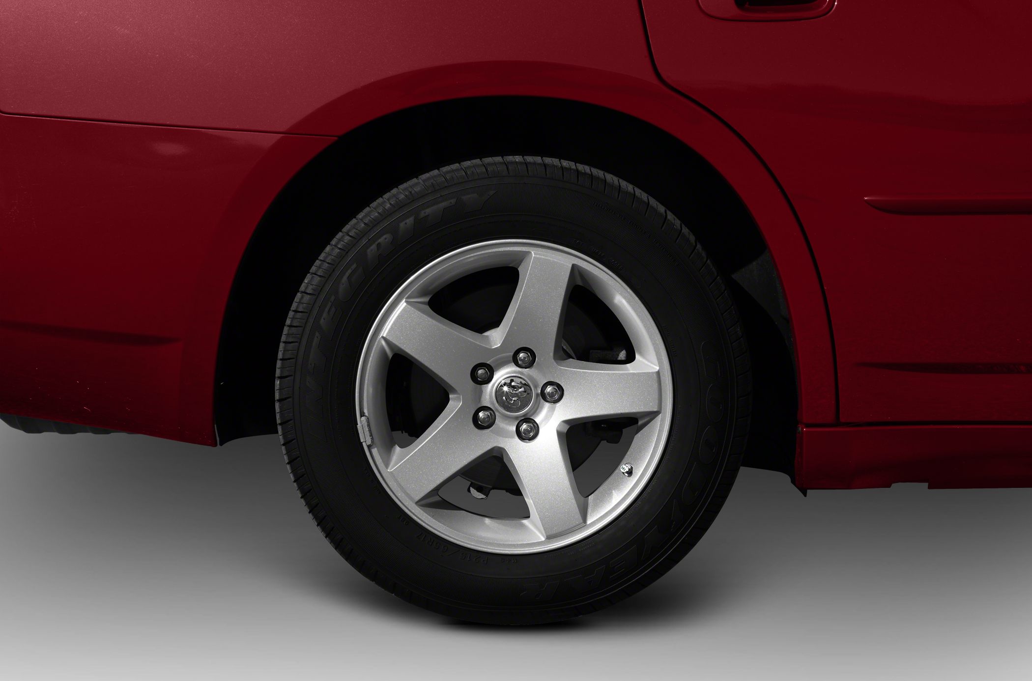 Close-up of five-spoke alloy wheel with Goodyear tire on car rear side