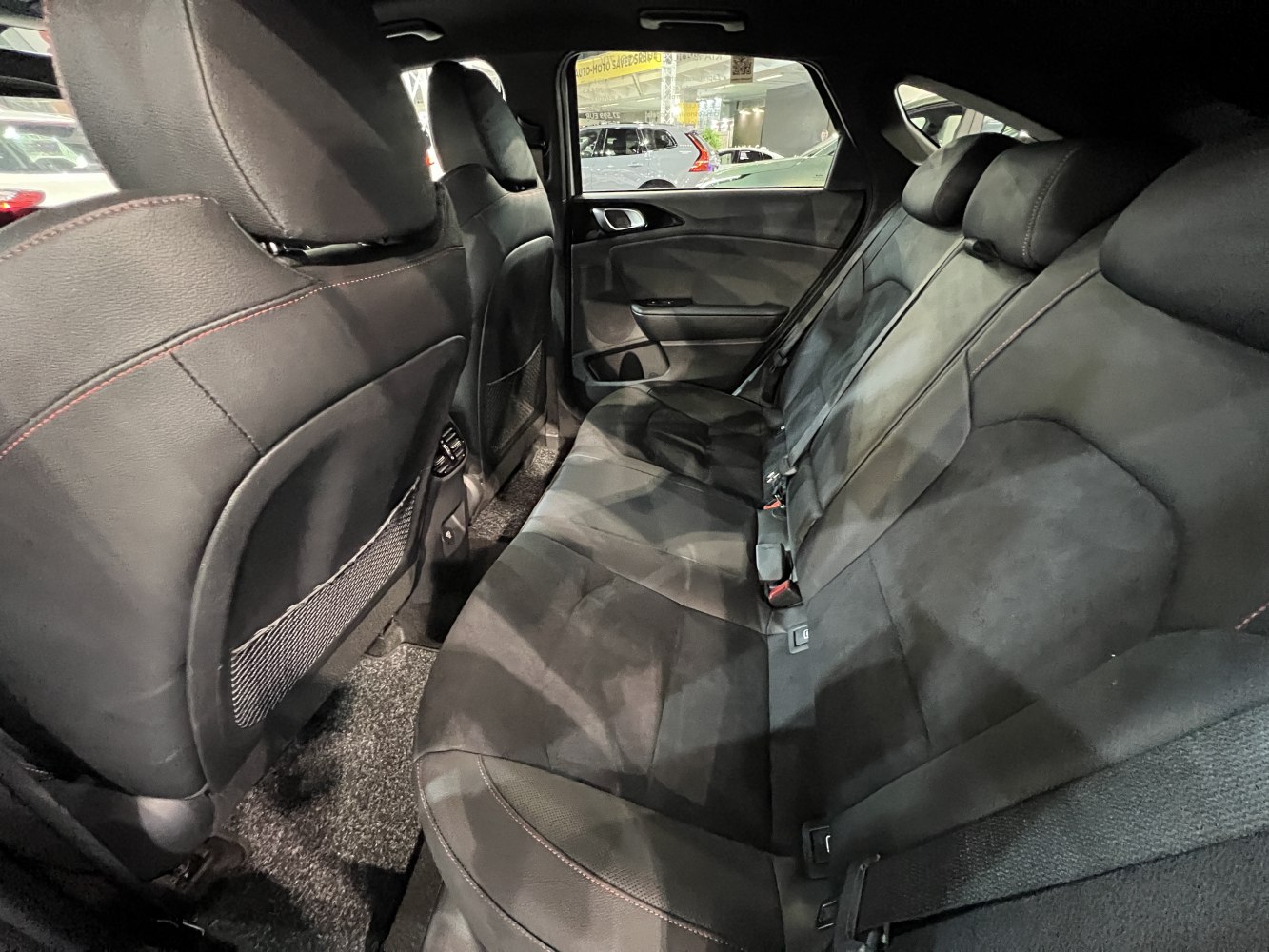 Black leather and suede rear seats with red stitching and seat belts
