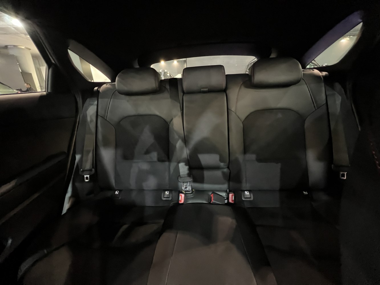 Black upholstered rear seats with 3 headrests and seat belts