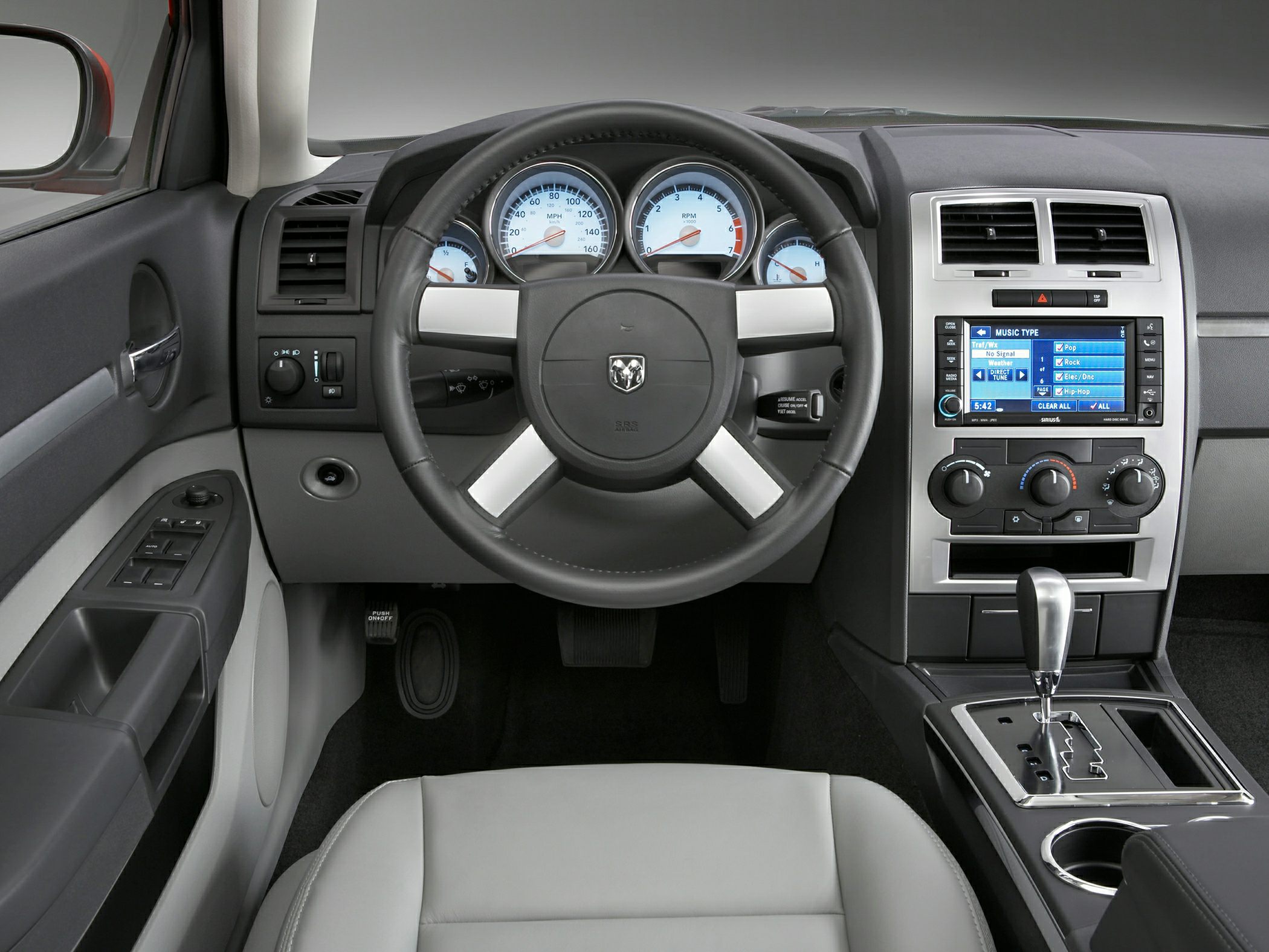 Steering wheel, dashboard gauges, center console with gear shift and controls