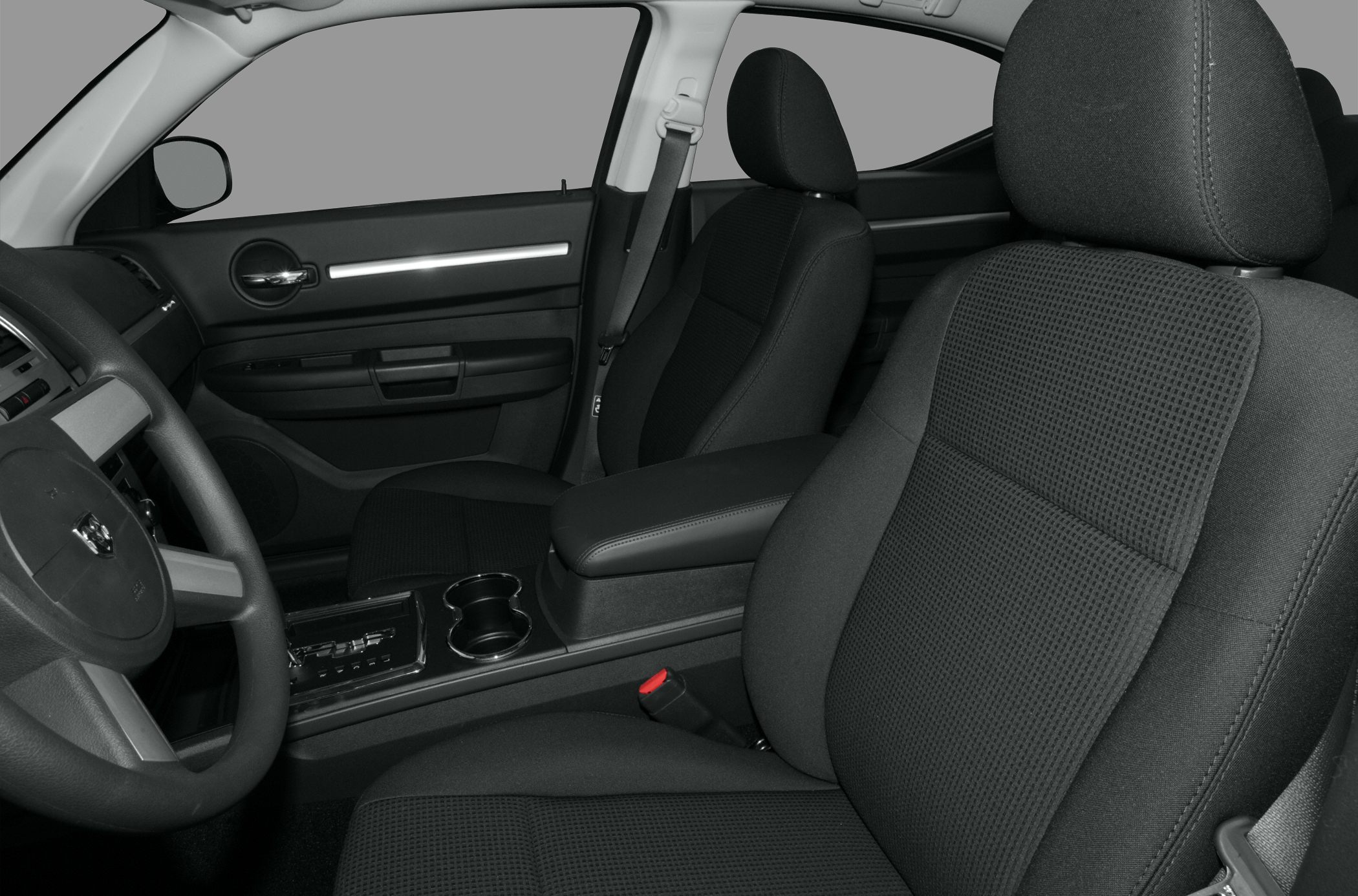 Front interior seating with cloth upholstery, center console, and steering wheel.