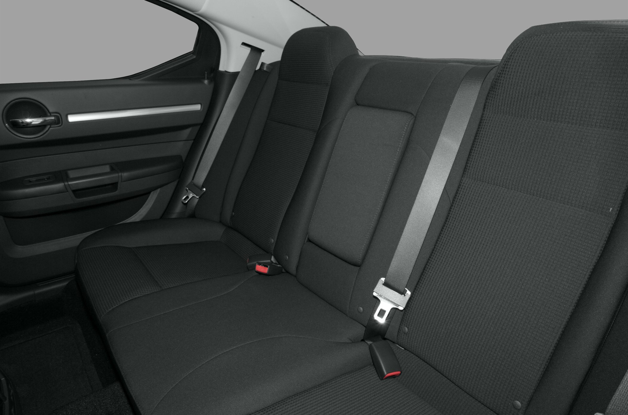 Black fabric rear seat with seatbelt and upholstery details