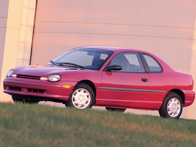 Side profile of a red two-door coupe with round headlights