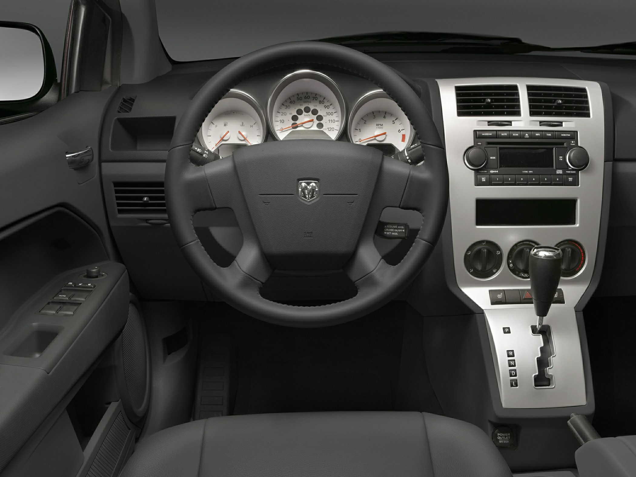 Steering wheel, dashboard instrument cluster, and center console with gear shift