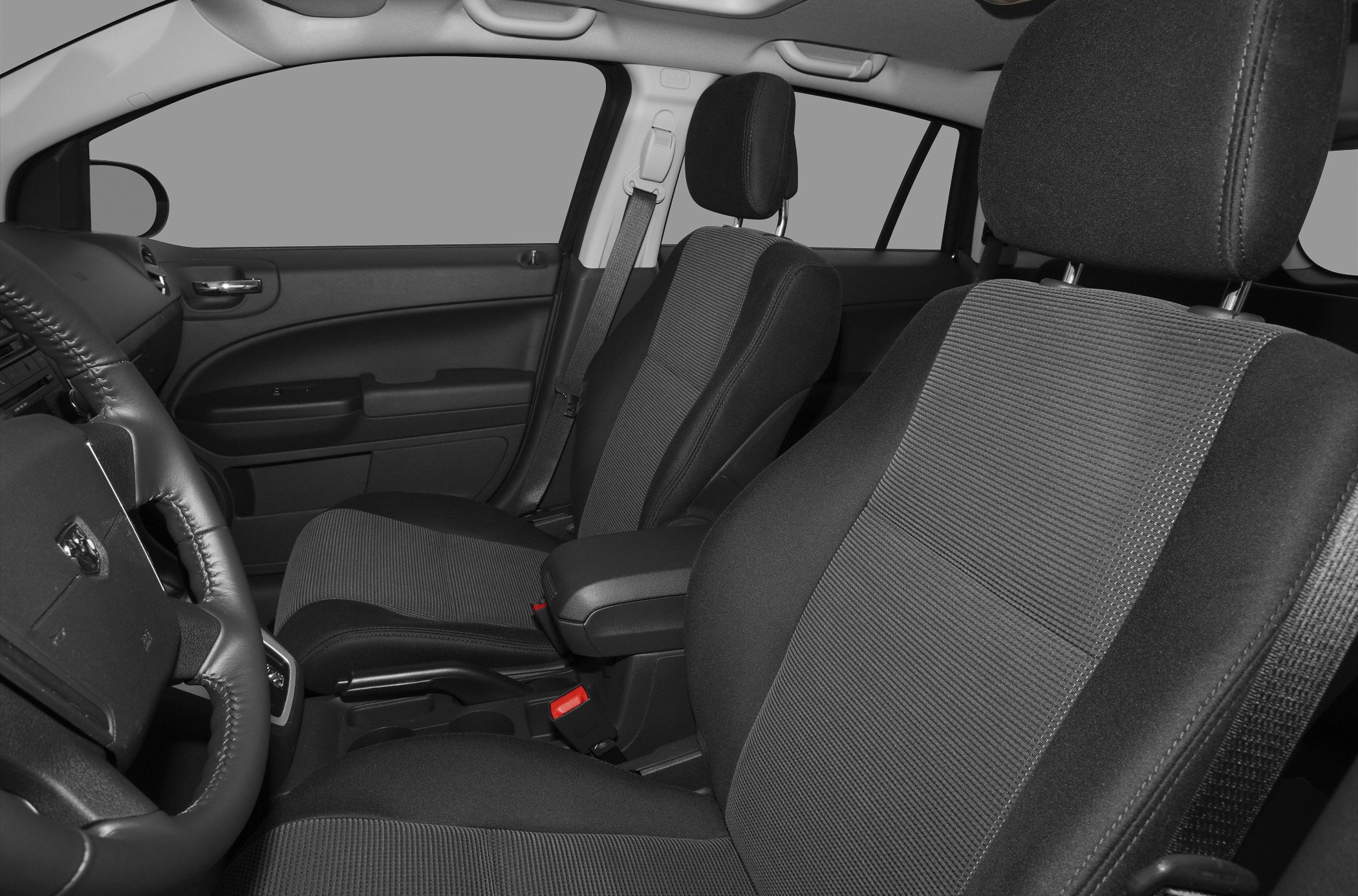Front passenger and driver seats with steering wheel and door panel.