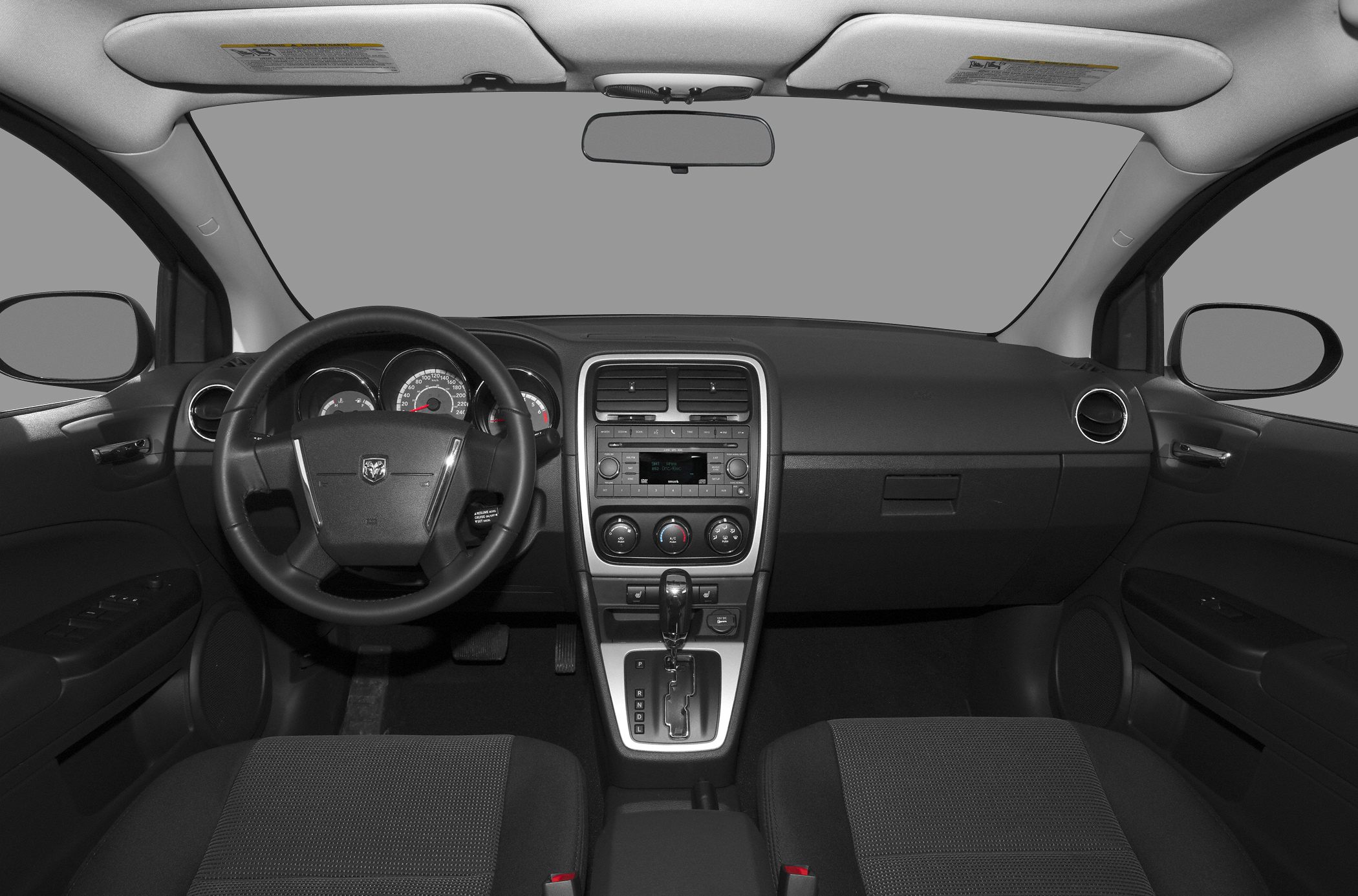 Car interior view with dashboard, steering wheel, and center console