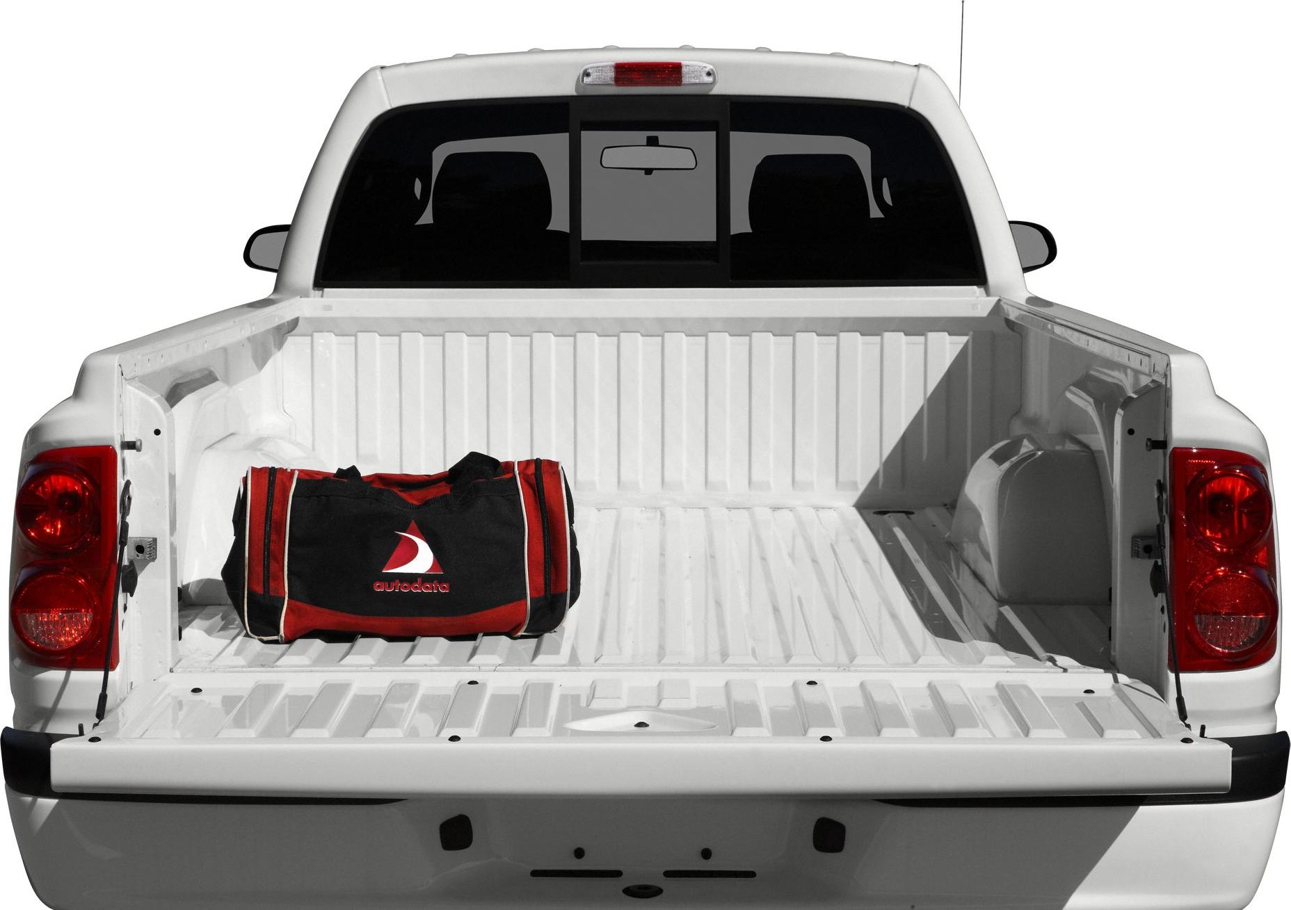 Spacious white pickup truck bed with a black and red bag