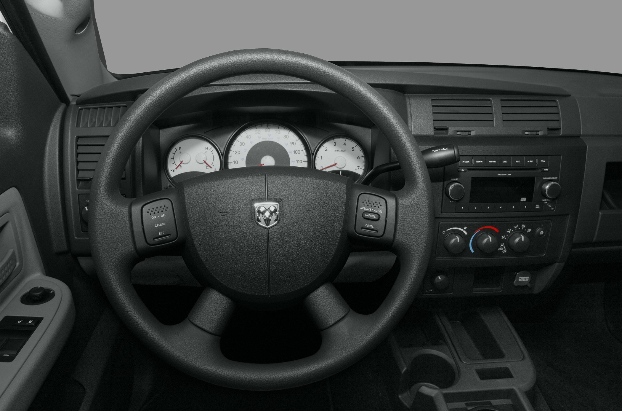 Steering wheel and dashboard with gauges and control buttons