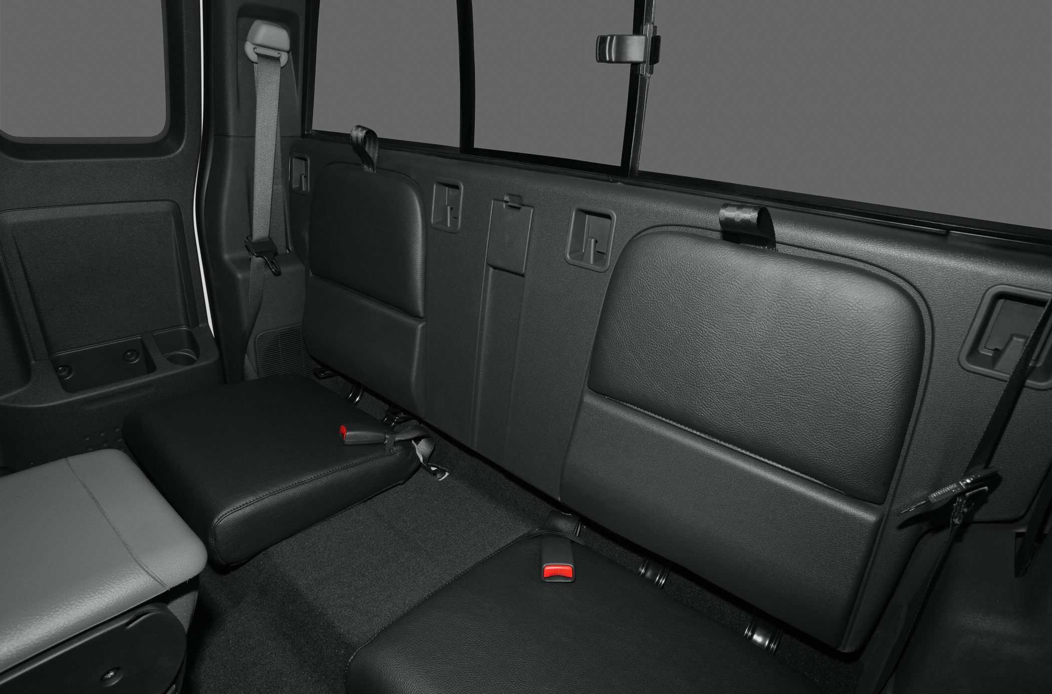 Foldable rear seat with seatbelts in pickup truck interior
